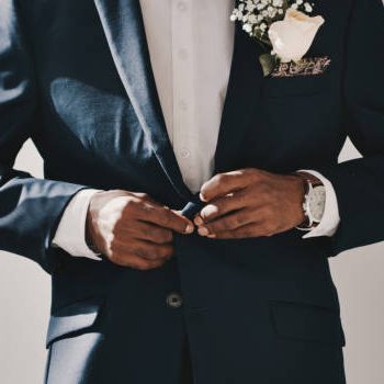 Cropped shot of an unrecognizable groom standing alone and getting ready before his wedding